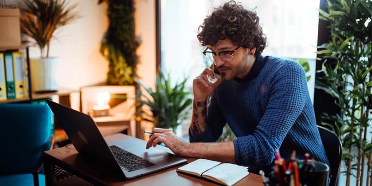 Man in glasses sitting at desk