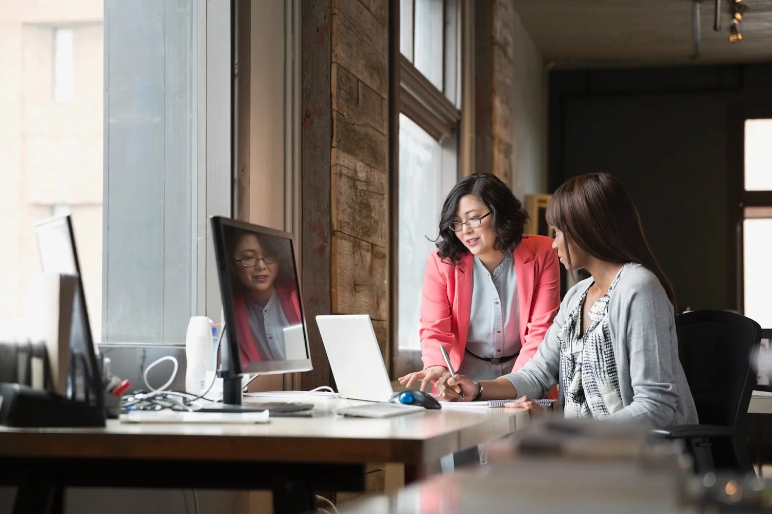 Two women looking a laptop