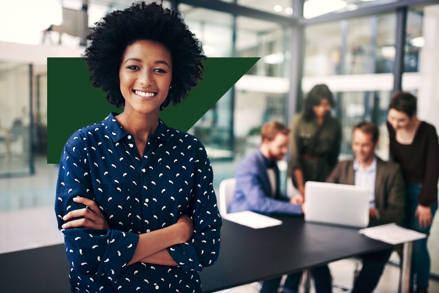 Smiling woman with arms crossed, standing in front of SAP Concur logo