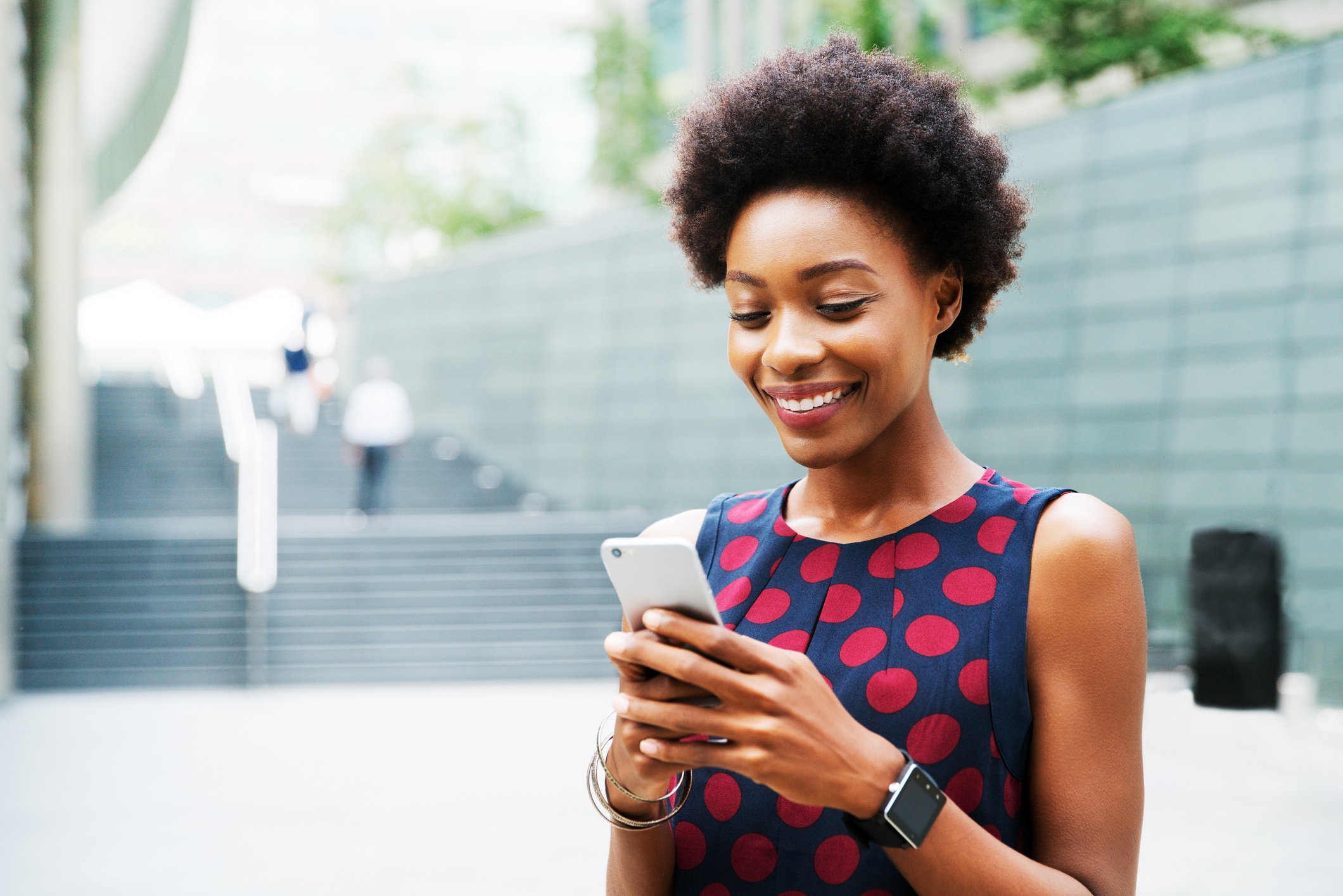 Woman holding phone and smiling