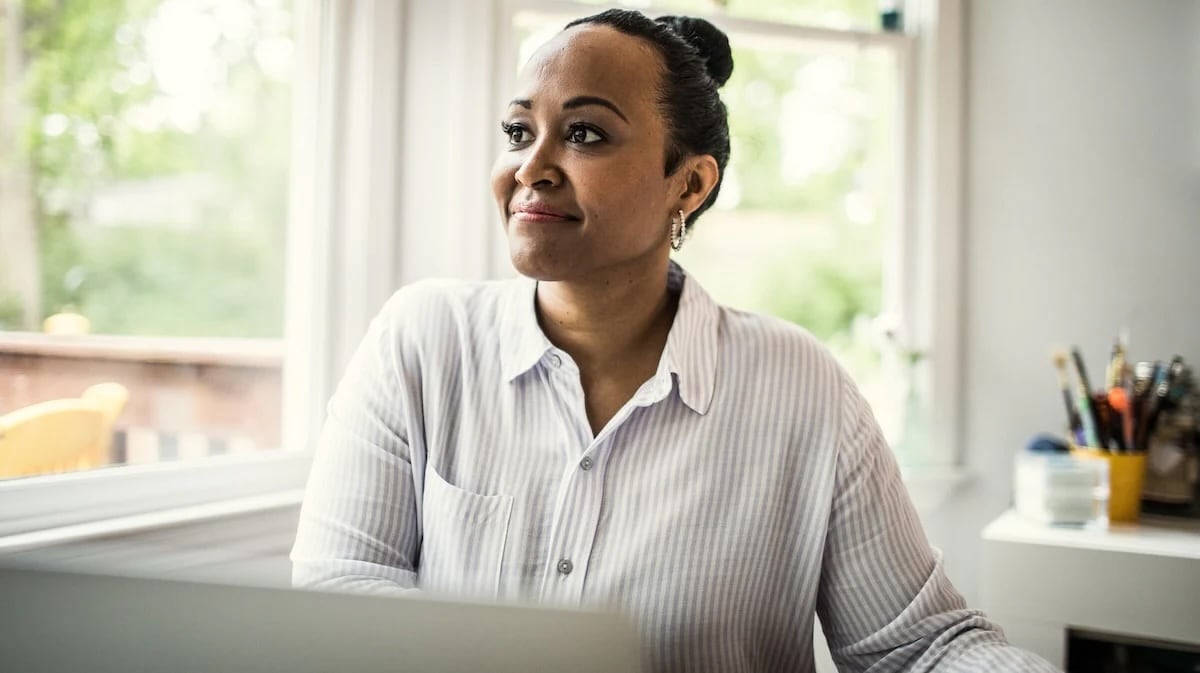 Woman with hair in bun sitting at desk