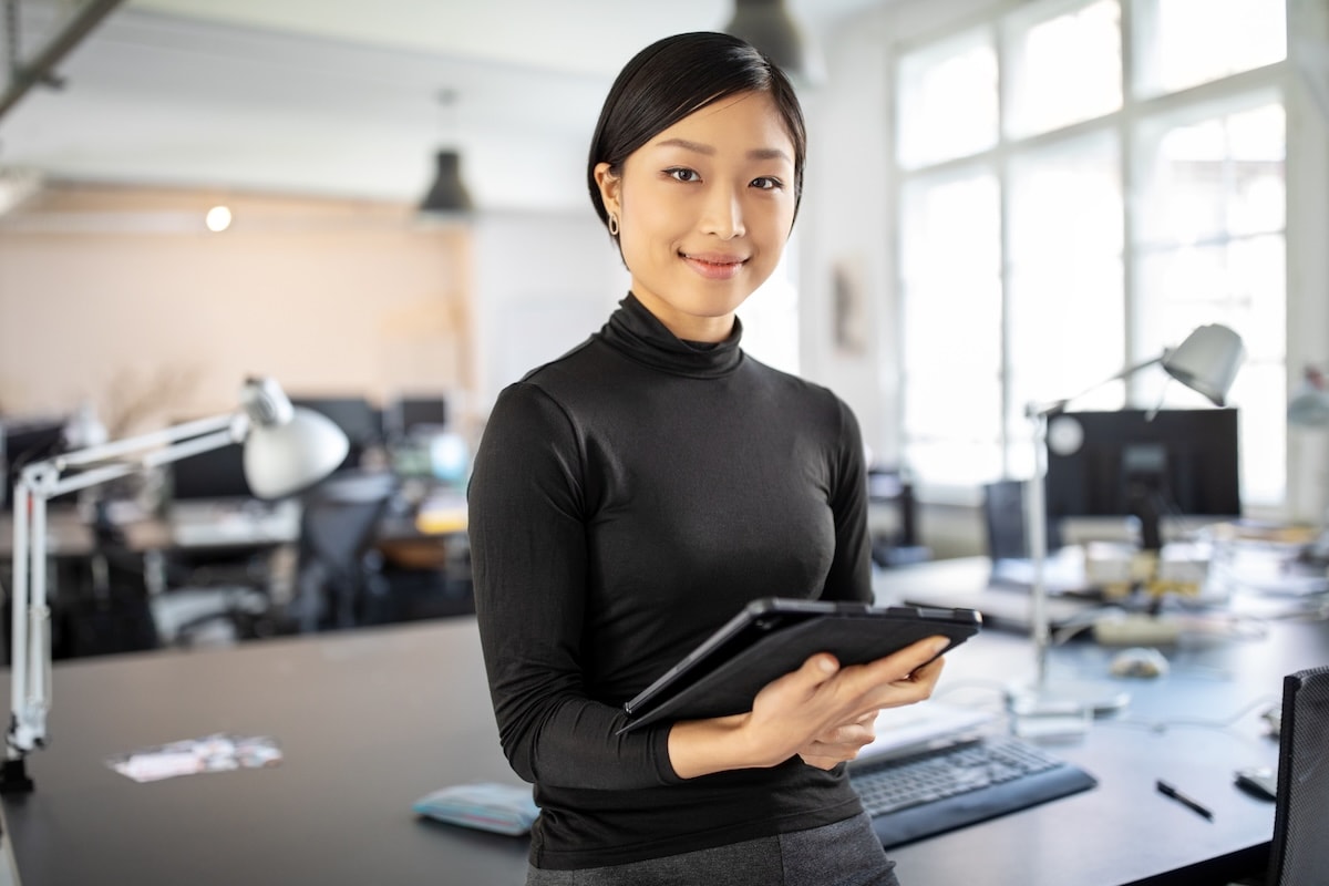 East asian woman holding tablet