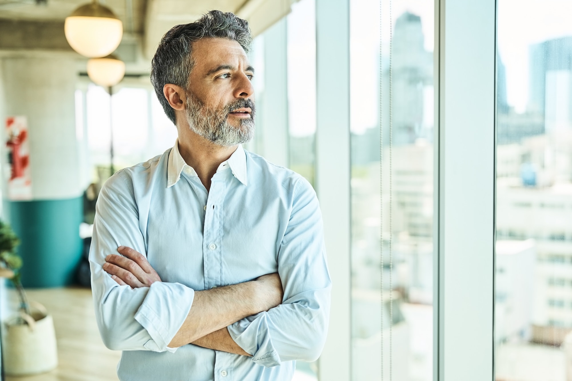 Man with beard crosses his arms