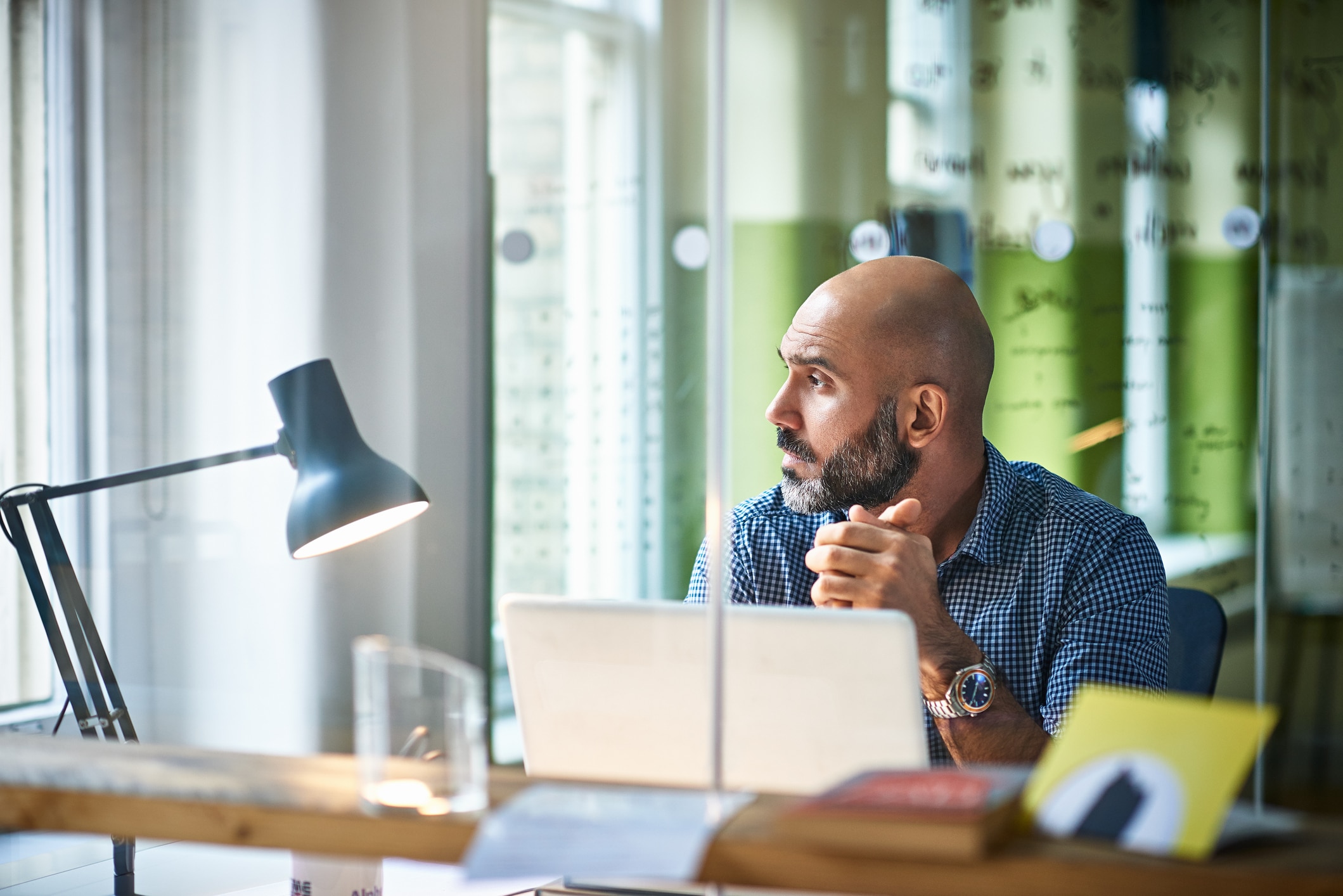 Man with laptop looks off to the side