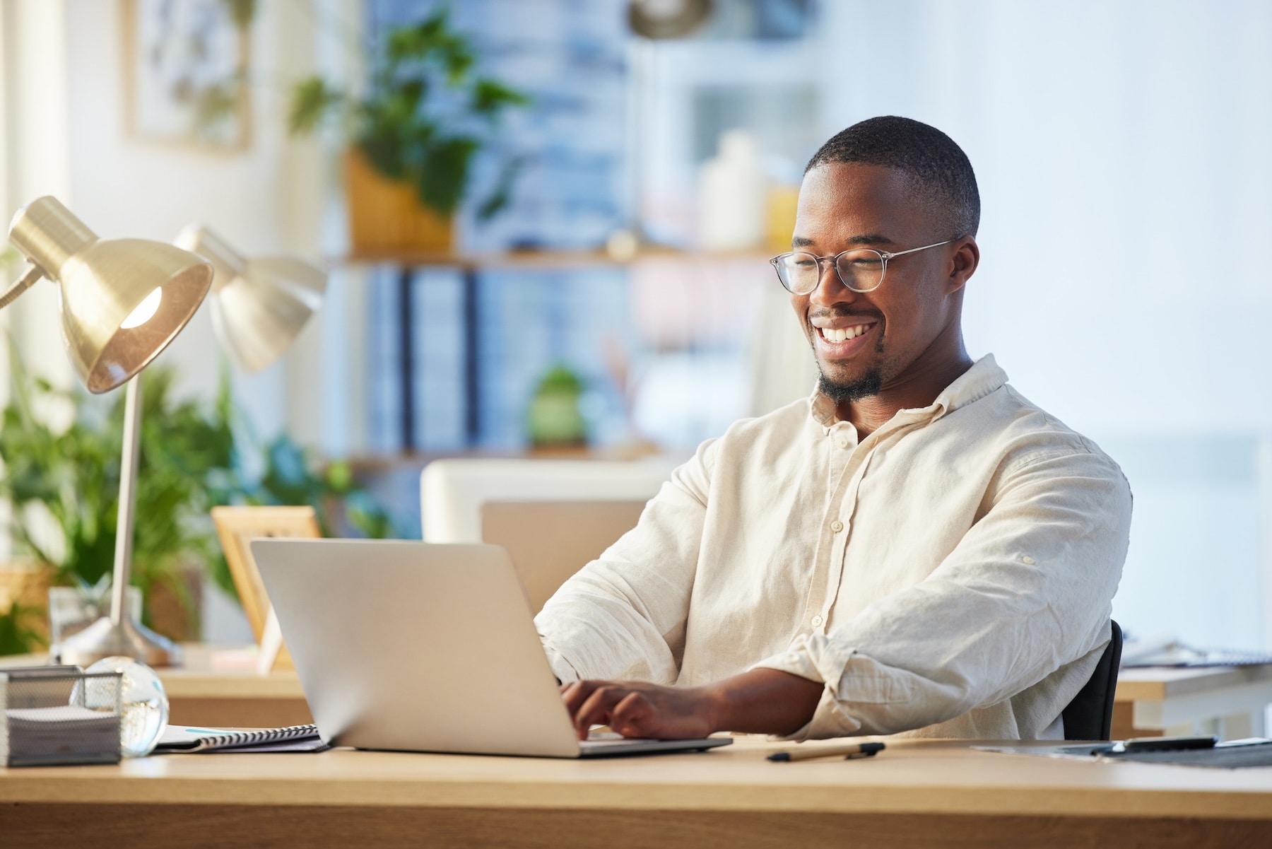 Smiling man working on laptop