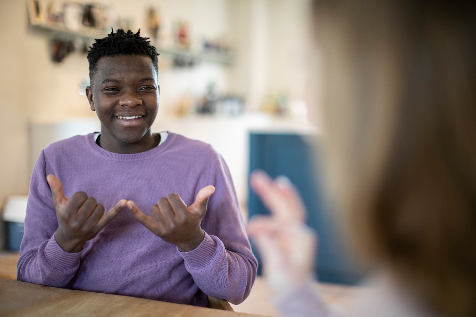 Smiling man using sign language