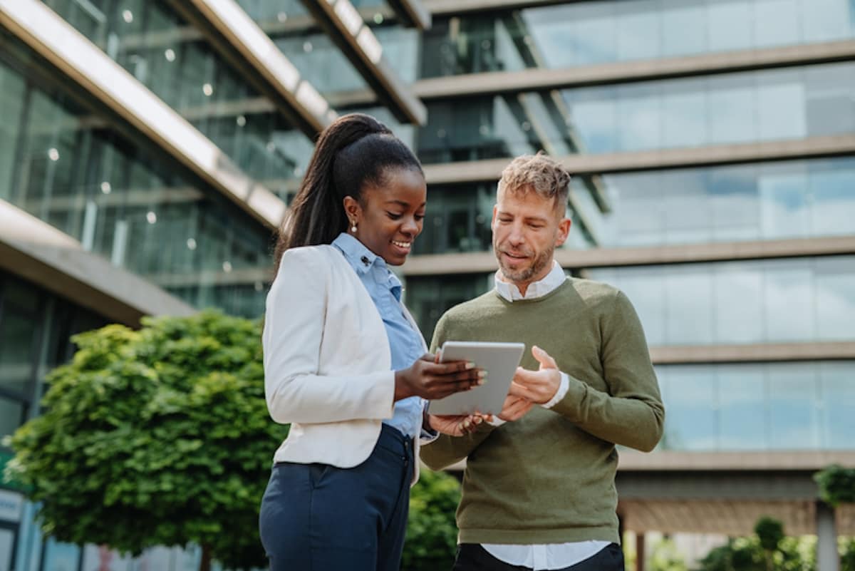 Two happy SAP Concur users using a tablet