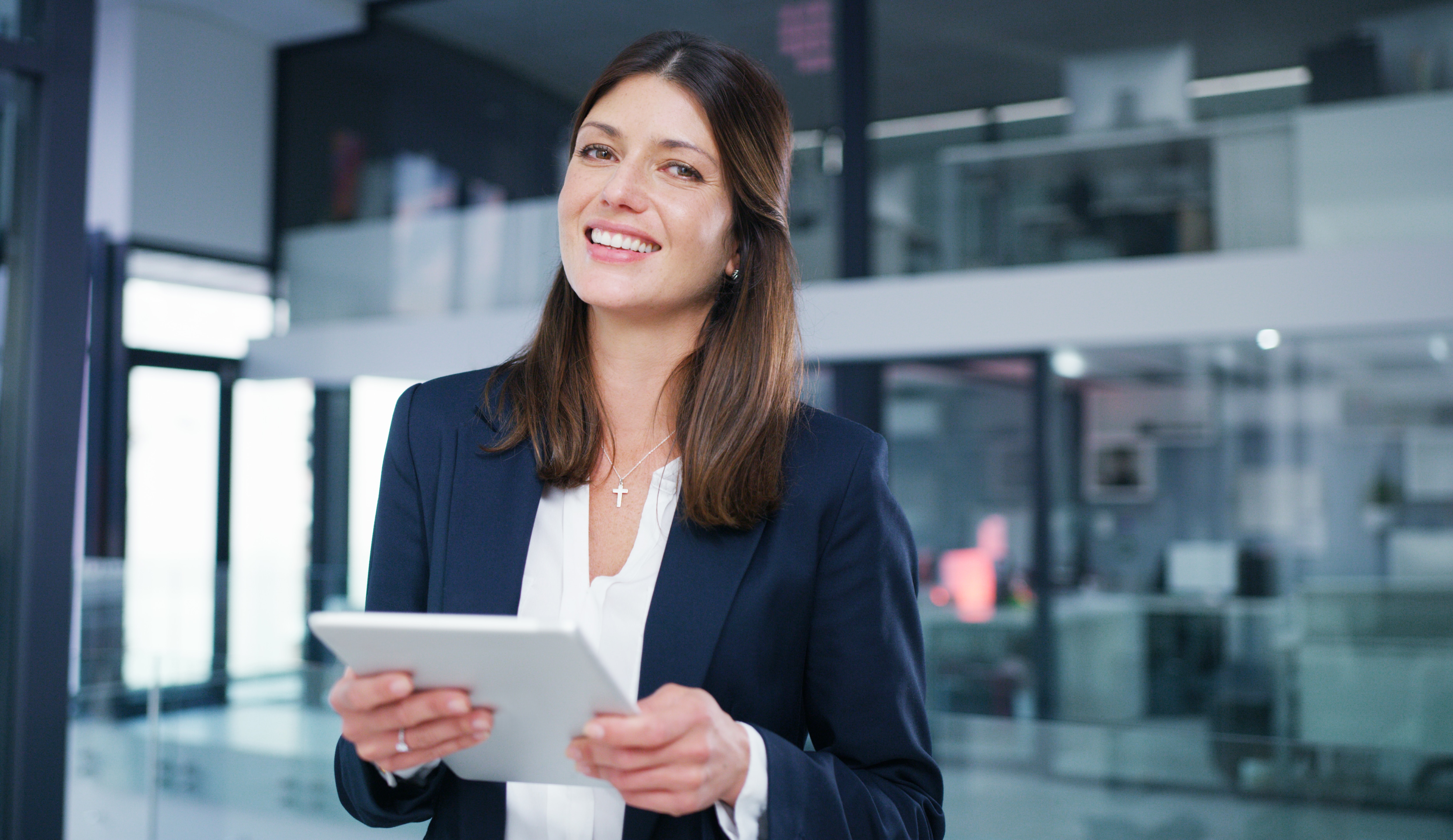 An SAP Concur Solutions user, Jessica, stands holding a tablet