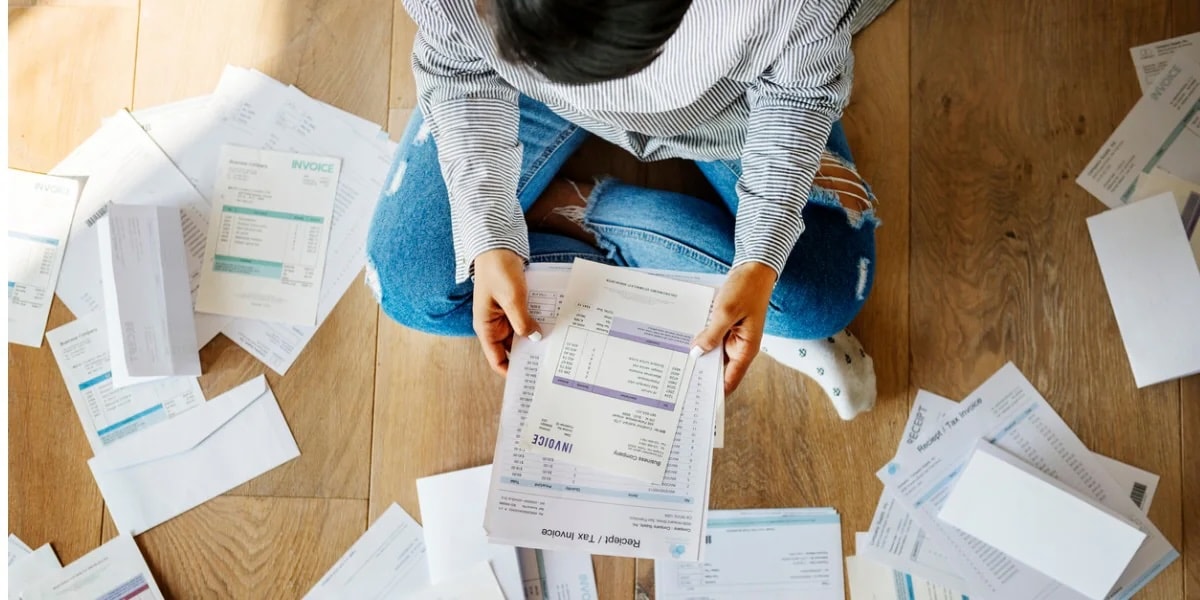 Woman sorting through receipts and expense reports